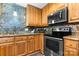 Kitchen with stainless steel appliances, modern backsplash and wood cabinets at 220 Pinehurst Ln, Newton, NC 28658