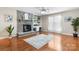 Spacious living room featuring a brick fireplace, built-in shelving and desk space, and gleaming hardwood floors at 220 Pinehurst Ln, Newton, NC 28658