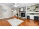 Welcoming living room with hardwood floors, brick fireplace, and built-in shelves and desk space at 220 Pinehurst Ln, Newton, NC 28658