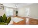 Bright living room featuring hardwood floors, large windows, and a ceiling fan for comfortable living at 220 Pinehurst Ln, Newton, NC 28658