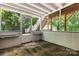 Enclosed porch with wood beams and view of stairs leading to upper level at 220 Pinehurst Ln, Newton, NC 28658