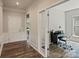 Bright foyer with hardwood flooring leading to a study with glass French doors and trim work at 2329 Delaney Dr, Fort Mill, SC 29715