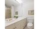 Bathroom with vanity, a large mirror, wainscotting and neutral finishes at 2445 Selwyn Ave # 104, Charlotte, NC 28209