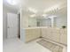 Bathroom featuring double vanities, large mirrors, and ample lighting at 2445 Selwyn Ave # 104, Charlotte, NC 28209