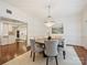 Bright dining area features hardwood floors, views of the kitchen, and a modern chandelier at 2445 Selwyn Ave # 104, Charlotte, NC 28209