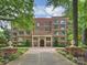 A stately brick building with meticulous landscaping showcases a refined elegance for The Sterling at 2445 Selwyn Ave # 104, Charlotte, NC 28209