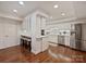 Bright kitchen features stainless steel appliances, white cabinets, and hardwood floors at 2445 Selwyn Ave # 104, Charlotte, NC 28209