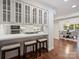 Modern kitchen has counter seating, white cabinets, stainless appliances, and hardwood floors at 2445 Selwyn Ave # 104, Charlotte, NC 28209