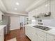 Bright kitchen featuring white cabinetry, countertops, and stainless steel appliances, all complemented by warm hardwood floors at 2445 Selwyn Ave # 104, Charlotte, NC 28209