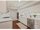 Modern kitchen features white cabinets, stainless steel appliances, and hardwood floors at 2445 Selwyn Ave # 104, Charlotte, NC 28209