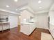 Bright kitchen featuring white cabinetry, countertops, and modern appliances, all complemented by warm hardwood floors at 2445 Selwyn Ave # 104, Charlotte, NC 28209