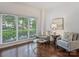 Bright sitting room features beautiful wood floors and large windows at 2445 Selwyn Ave # 104, Charlotte, NC 28209