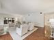 A bright living room with hardwood floors, fireplace, modern furniture, and access to the patio at 2445 Selwyn Ave # 104, Charlotte, NC 28209