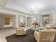 Well-lit lobby featuring arm chairs, chandelier, and sleek, modern design elements create a welcoming atmosphere at 2445 Selwyn Ave # 104, Charlotte, NC 28209