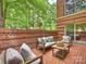 Inviting patio features brick accents, comfortable seating, and lush greenery for outdoor relaxation at 2445 Selwyn Ave # 104, Charlotte, NC 28209