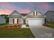 Charming single-Gathering home featuring a two-car garage, manicured lawn, and beautiful landscaping at twilight at 2928 Parkwest Dr, Albemarle, NC 28001