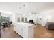 Open kitchen with a white island, stainless steel appliances, and hardwood floors at 2928 Parkwest Dr, Albemarle, NC 28001