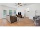 Living room with a ceiling fan, hardwood floors and large windows at 2928 Parkwest Dr, Albemarle, NC 28001