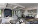 Open floor plan with fireplace, coffered ceilings, and modern kitchen featuring stainless steel appliances and bar seating at 305 S Gardner Ave, Charlotte, NC 28208