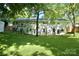 Spacious backyard view showcasing the home's exterior, landscaping, and mature trees at 3549 Woodleaf Rd, Charlotte, NC 28205