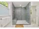 Modern bathroom showcasing a glass-enclosed shower with gray tiled walls and a built-in bench at 3549 Woodleaf Rd, Charlotte, NC 28205