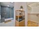 Modern bathroom featuring a tiled shower, storage shelves, and contemporary design at 3549 Woodleaf Rd, Charlotte, NC 28205