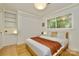 Cozy bedroom with a queen bed and a built-in cabinet and drawer unit at 3549 Woodleaf Rd, Charlotte, NC 28205