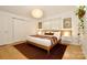Bright bedroom with a plush bed, modern lighting, and a sliding door for privacy at 3549 Woodleaf Rd, Charlotte, NC 28205