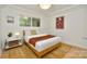 Cozy bedroom with natural light, a comfortable bed, and a view of the surrounding greenery at 3549 Woodleaf Rd, Charlotte, NC 28205