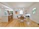 Inviting dining area with modern lighting, a stylish table set, and open view to the kitchen at 3549 Woodleaf Rd, Charlotte, NC 28205