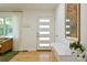 A bright and inviting foyer with a modern front door and stylish console table with houseplant at 3549 Woodleaf Rd, Charlotte, NC 28205