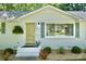 Close-up of a bright, freshly painted white brick home with an attractive, contrasting yellow front door at 3549 Woodleaf Rd, Charlotte, NC 28205