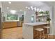 Bright kitchen with stainless steel appliances, a marble countertop island, and modern lighting at 3549 Woodleaf Rd, Charlotte, NC 28205