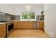 Kitchen featuring stainless steel appliances, light wood cabinetry, and plenty of natural light at 3549 Woodleaf Rd, Charlotte, NC 28205