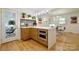 Well-lit kitchen featuring a marble countertop island, built in oven, and hardwood floors at 3549 Woodleaf Rd, Charlotte, NC 28205