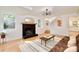 Inviting living room with a black brick fireplace, hardwood floors, and ample natural light at 3549 Woodleaf Rd, Charlotte, NC 28205