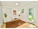 Bright home office with a modern desk and a door leading to the outdoors at 3549 Woodleaf Rd, Charlotte, NC 28205