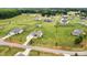 Aerial view showcases a home on a well-manicured lawn with outbuildings, bordered by fencing, in a community setting at 3645 Kimber Ln, Sherrills Ford, NC 28673