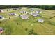 Drone view showcasing a home with sprawling green lawn, outbuilding, and neighborhood, offering space and a sense of community at 3645 Kimber Ln, Sherrills Ford, NC 28673