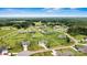 Expansive aerial view of a home and its surrounding property in a well-manicured neighborhood with lush greenery and clear blue skies at 3645 Kimber Ln, Sherrills Ford, NC 28673