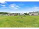 Spacious backyard with a house, covered patio, shed, and a well-manicured green lawn at 3645 Kimber Ln, Sherrills Ford, NC 28673