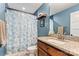 Cozy bathroom featuring a stylish vanity with a granite countertop and blue floral shower curtain at 3645 Kimber Ln, Sherrills Ford, NC 28673