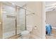 Bathroom with a walk-in shower featuring decorative tile work, a toilet, and a view of the bedroom at 3645 Kimber Ln, Sherrills Ford, NC 28673