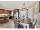 Dining area with modern chandelier, wooden table, metal chairs, and a view into kitchen and sunroom at 3645 Kimber Ln, Sherrills Ford, NC 28673