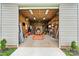 A large garage with a tractor inside, featuring storage shelves and ample workspace, perfect for hobbies and projects at 3645 Kimber Ln, Sherrills Ford, NC 28673