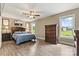 Relaxing main bedroom with wood-look floors, a ceiling fan, and bright windows at 3645 Kimber Ln, Sherrills Ford, NC 28673