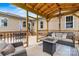 Inviting covered patio with a gas fire pit, comfortable seating, and an outdoor dining table at 3645 Kimber Ln, Sherrills Ford, NC 28673