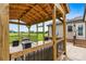 Inviting covered patio with an outdoor dining table and comfortable seating overlooking a large lawn at 3645 Kimber Ln, Sherrills Ford, NC 28673