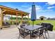 Inviting covered patio with a dining table and comfortable seating area overlooking a large lawn at 3645 Kimber Ln, Sherrills Ford, NC 28673