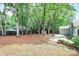 Landscaped backyard featuring mature trees, storage shed and patio, perfect for outdoor entertaining at 3708 Sweetgrass Ln, Charlotte, NC 28226